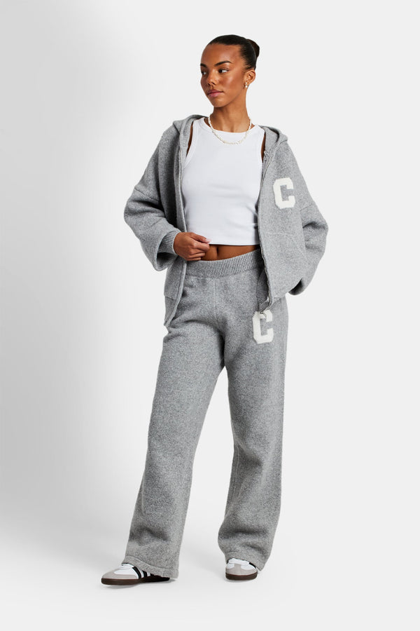 Female model wearing hooded zip through knitted tracksuit in grey
