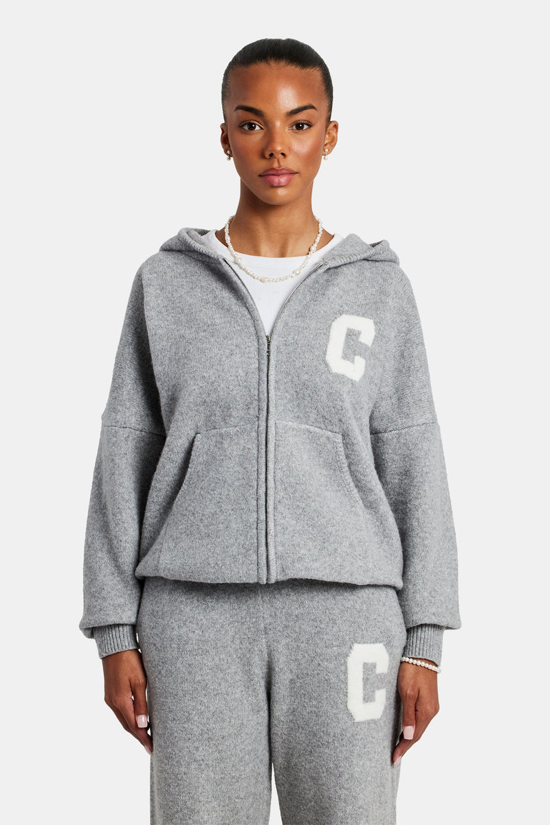 Female model wearing hooded zip through knitted tracksuit in grey