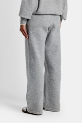 Female model wearing the wide leg knitted jogger in grey