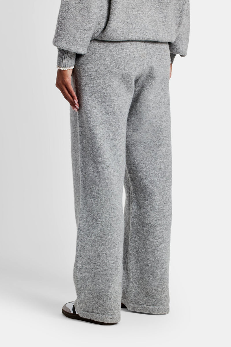 Female model wearing the wide leg knitted jogger in grey