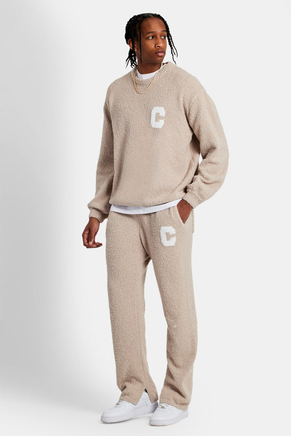 Male Model wearing textured knitted sweater tracksuit in beige