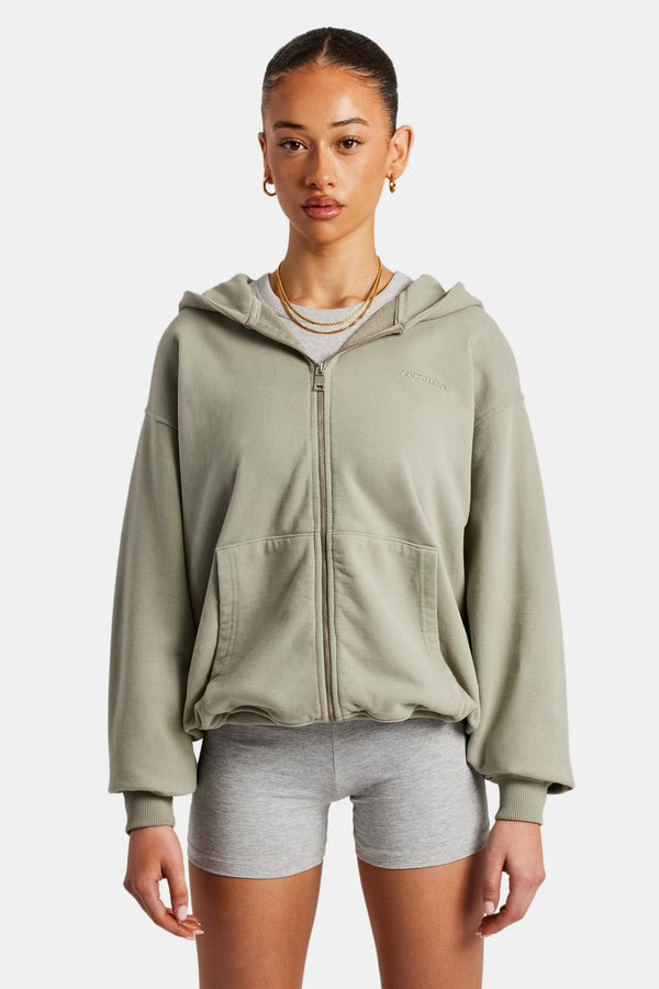 Female model wearing zip through sage hoodie