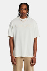 Male model wearing the tonal logo oversized t-shirt in off-white