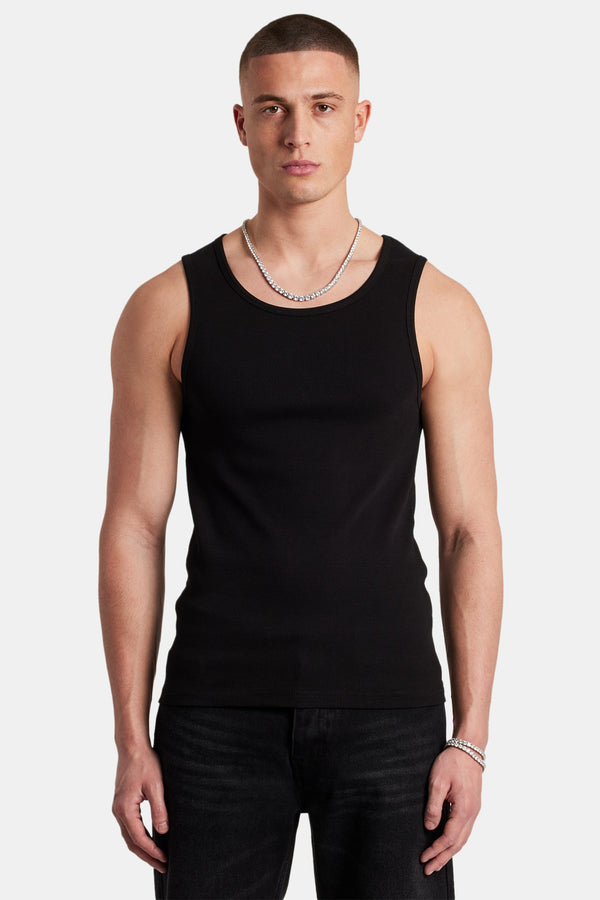 Model wearing black ribbed vest